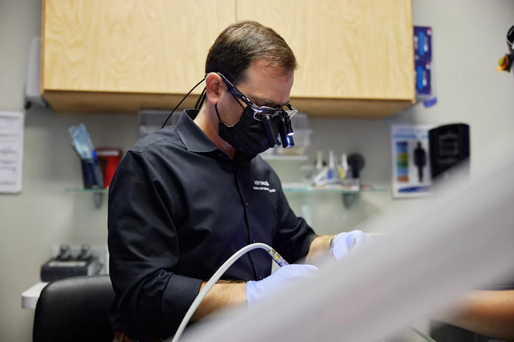 Dr. Chahine performing an impacted wisdom teeth removal at Just Smiles in Westerville.