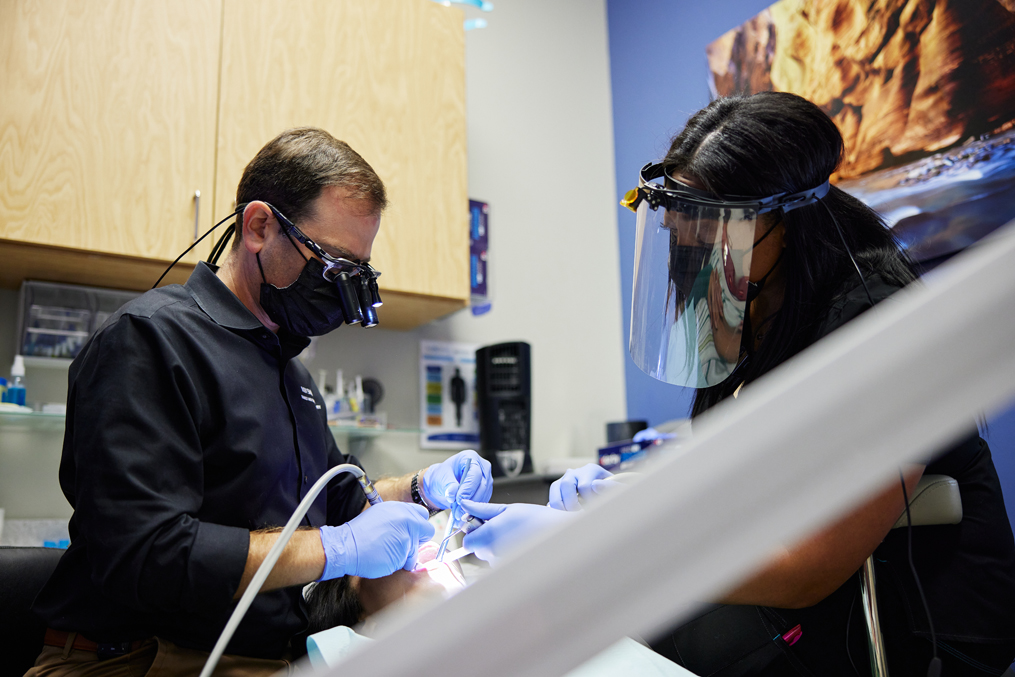 Drs. Chahine and Akah performing a tooth extraction in Westerville.