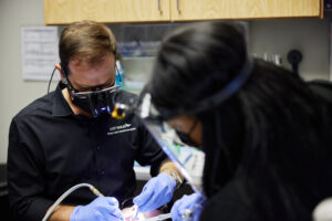 Hilliard OH dentist Dr. Phil Chahine performing a routine teeth cleaning for a Columbus patient.