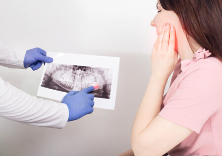 Hilliard dentist reviewing a panoramic X-ray of impacted wisdom teeth