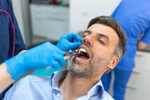 man having a tooth pulled in Westerville