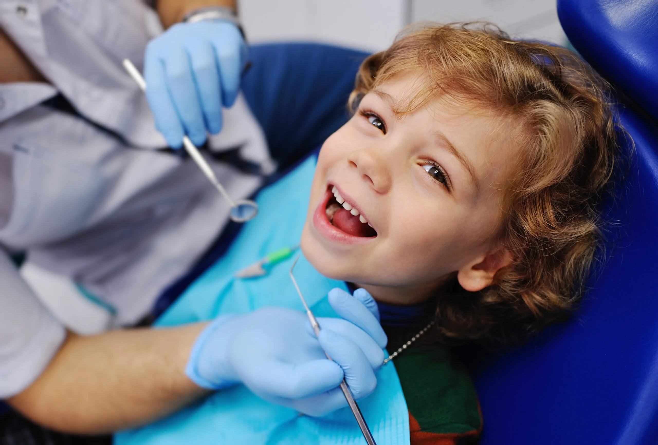 young boy smiling in a modern dental chair