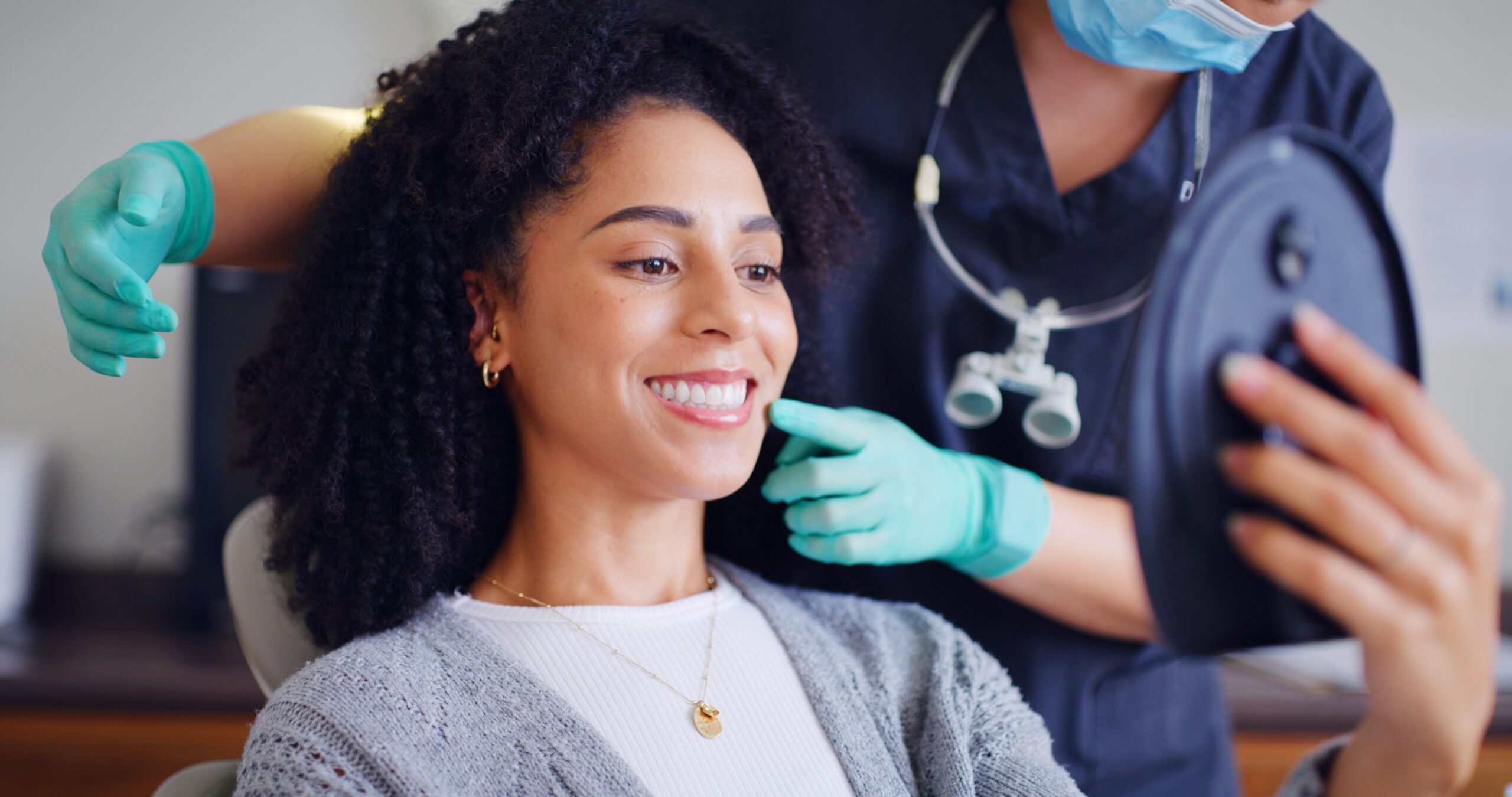 young woman smiling during a dental exam, perfect white teeth