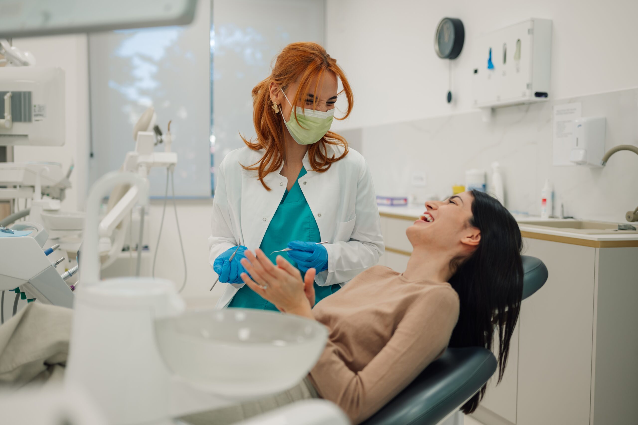 relaxed woman smiling in a dental chair, sedation dentistry